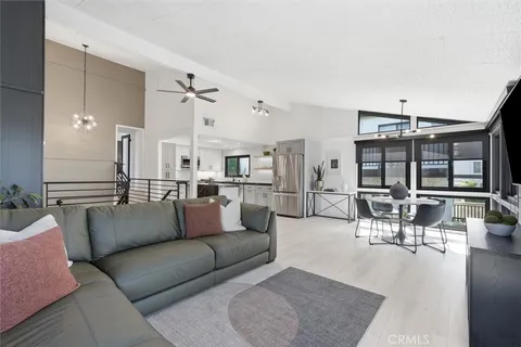 a living room with furniture and view of kitchen