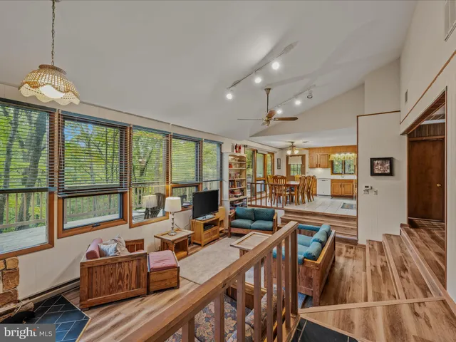 a living room with furniture and large windows