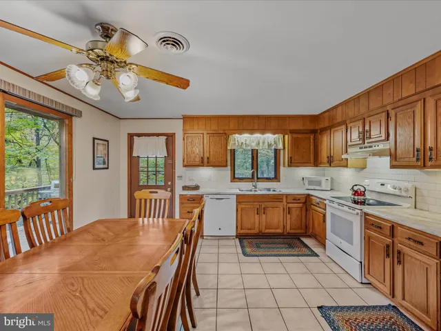a kitchen with a sink stove top oven and cabinets