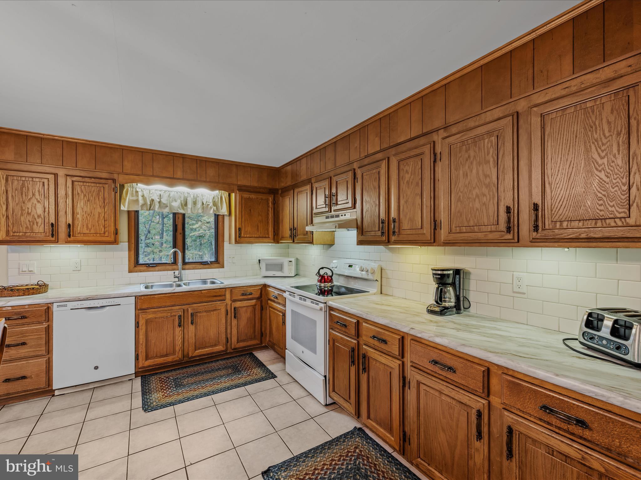 35 Warbler's Way Berkeley Springs, WV 25411 - Photo 15 of 54 a kitchen with a sink stove top oven and cabinets
