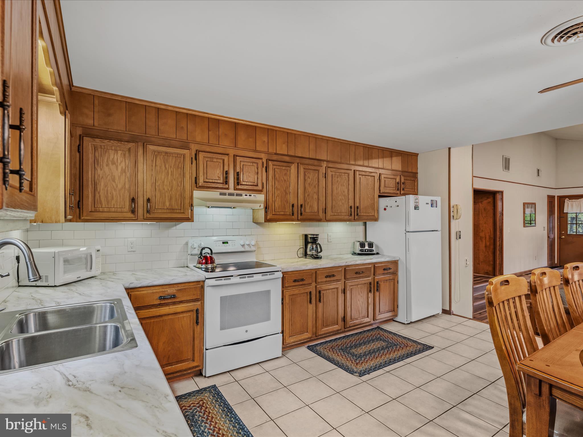 35 Warbler's Way Berkeley Springs, WV 25411 - Photo 16 of 54 a kitchen with stainless steel appliances granite countertop a sink stove refrigerator and cabinets