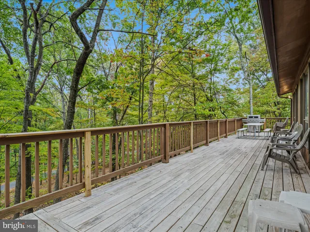 a view of balcony with wooden floor and fence