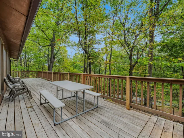 a view of balcony with wooden floor and outdoor seating