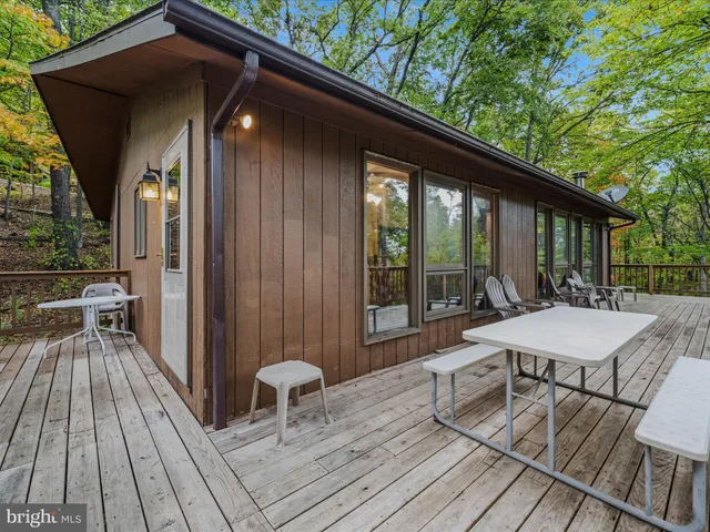a patio with wooden floor and outdoor seating