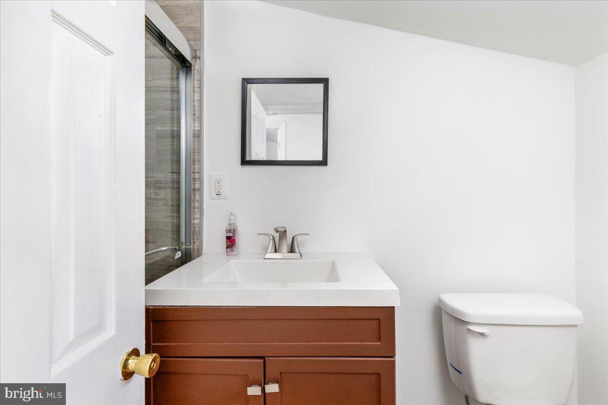 79 Bentonville Road Bentonville, VA 22610 - Photo 27 of 52 a bathroom with a sink a toilet and mirror