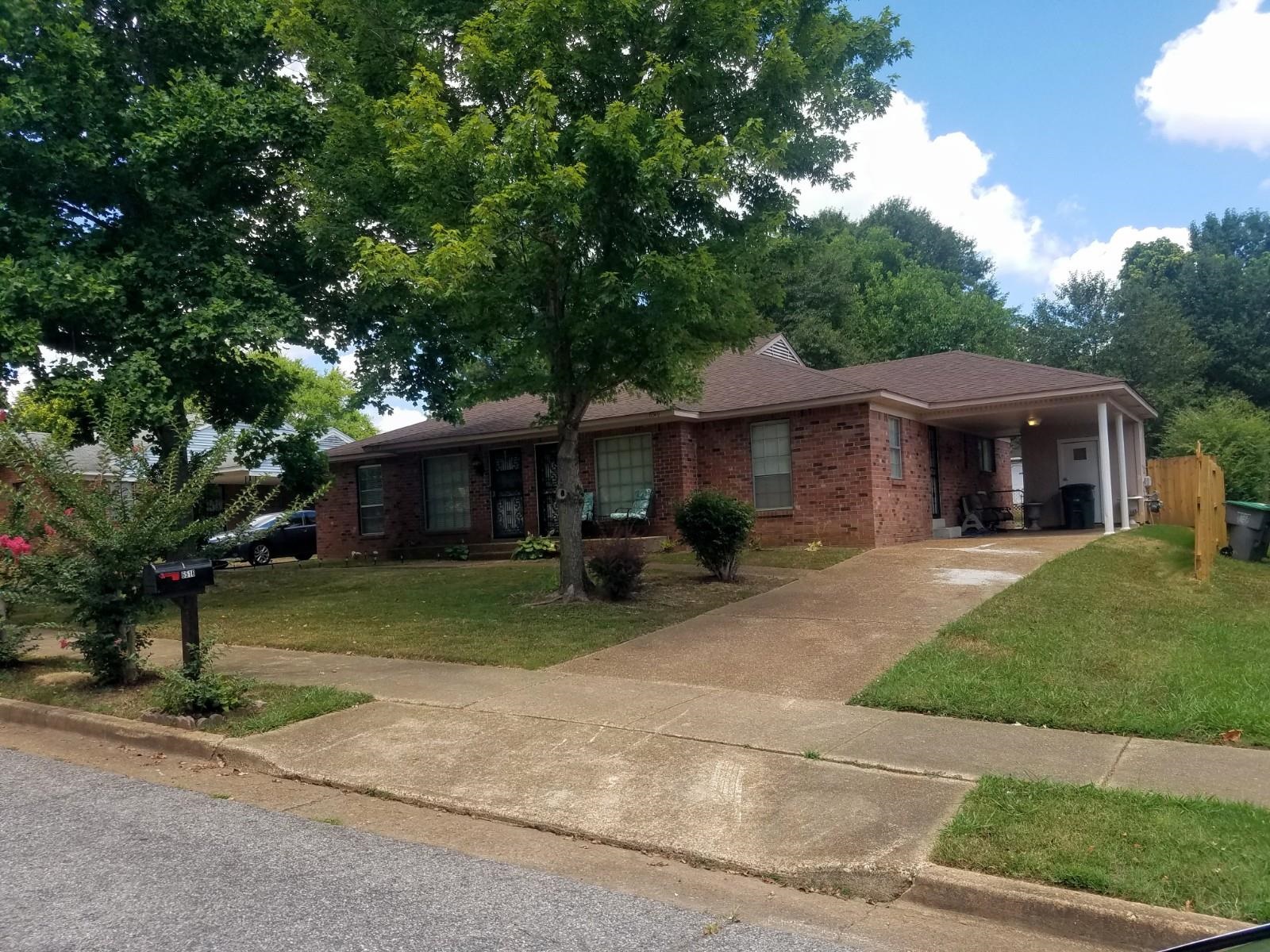 6514 Birkenhead Road Memphis, TN 38134 - Photo 3 of 3 a front view of a house with a yard and trees