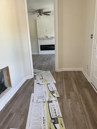 wooden floor with view of bathroom