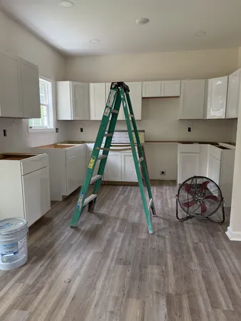 a room with wooden floors and white walls