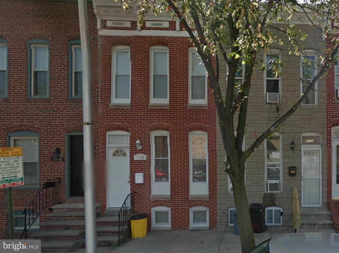 1116 South Paca Street Baltimore, MD 21230 - Photo 1 of 1 front view of a brick house with a large tree