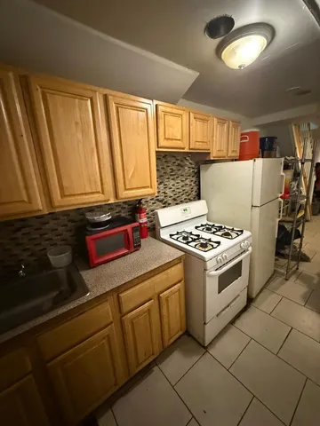 a kitchen with a stove and a refrigerator