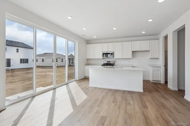 a view of a kitchen with wooden floor
