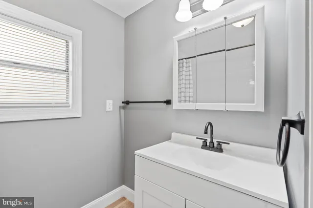 a bathroom with a sink a toilet and vanity