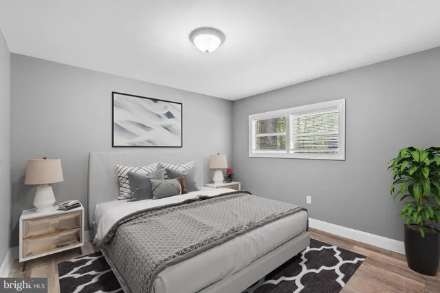 a bedroom with a bed and a potted plant