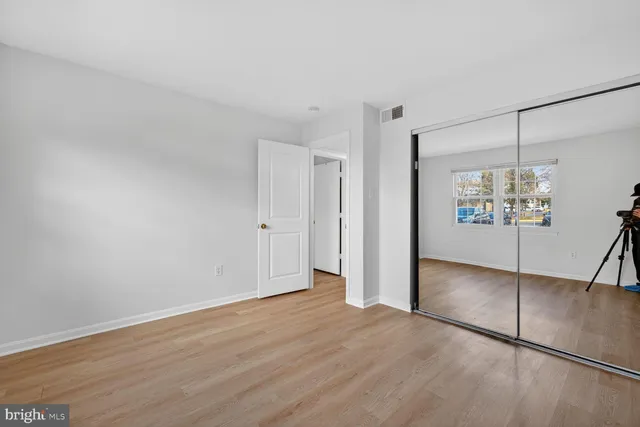 a view of a room with wooden floor