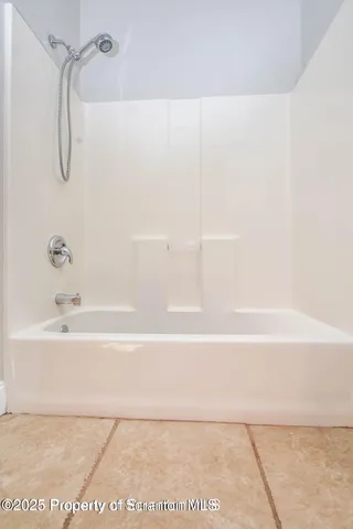 a bathroom with a shower and a bath tub