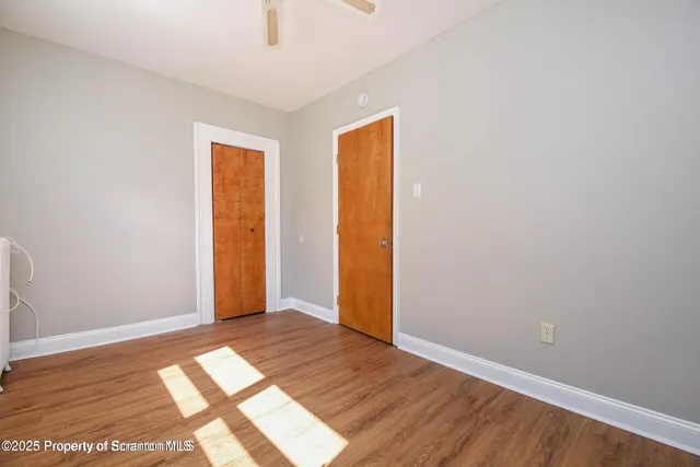 a view of a room with wooden floor