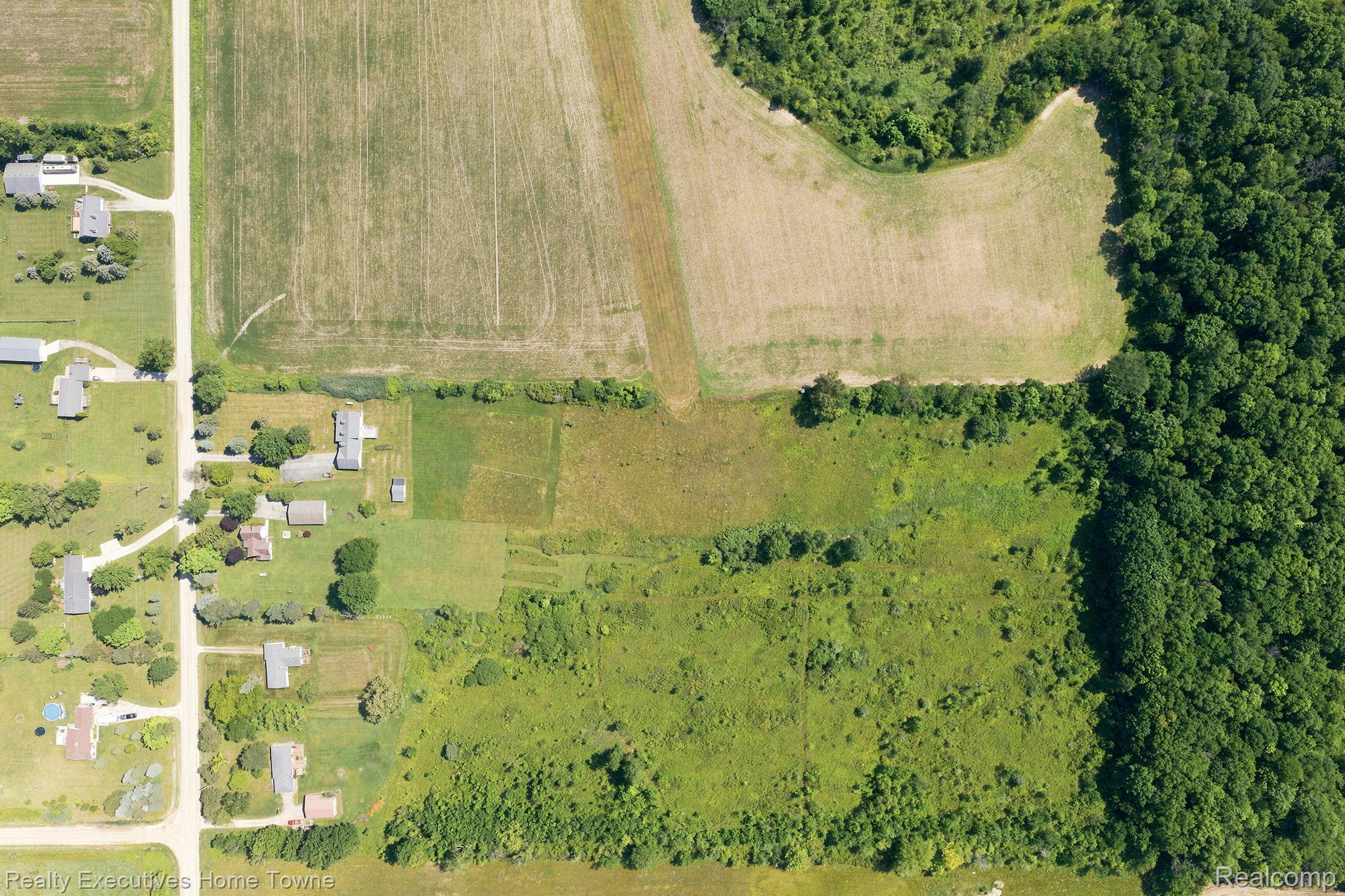 959 Braidwood Road Memphis, MI 48041 - Photo 5 of 58 Expansive land parcel featuring a perimeter of mature woodlands, open fields, and proximity to established residential areas
