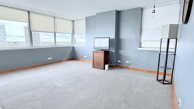 a view of room with window and a flat screen tv