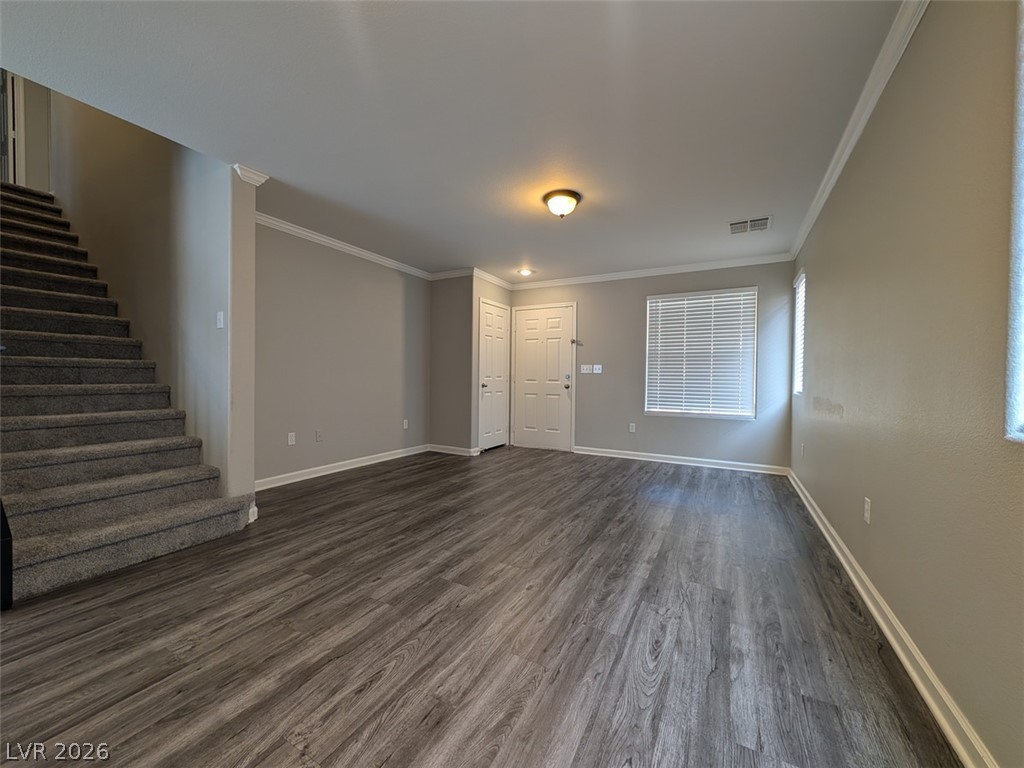 10308 Faustine Avenue Las Vegas, NV 89129 - Photo 3 of 28 A versatile living area features durable flooring, a welcoming entry, and convenient access to the upper level.