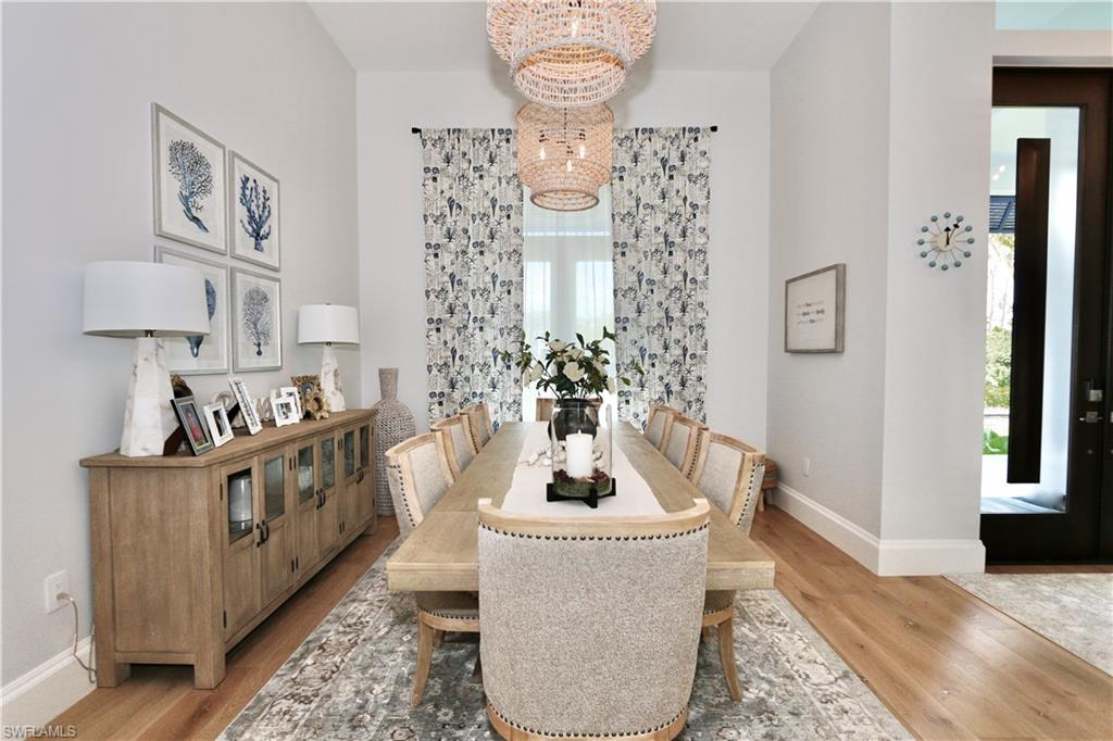 6688 Hunters Road Naples, FL 34109 - Photo 13 of 43 a living room with furniture and a chandelier