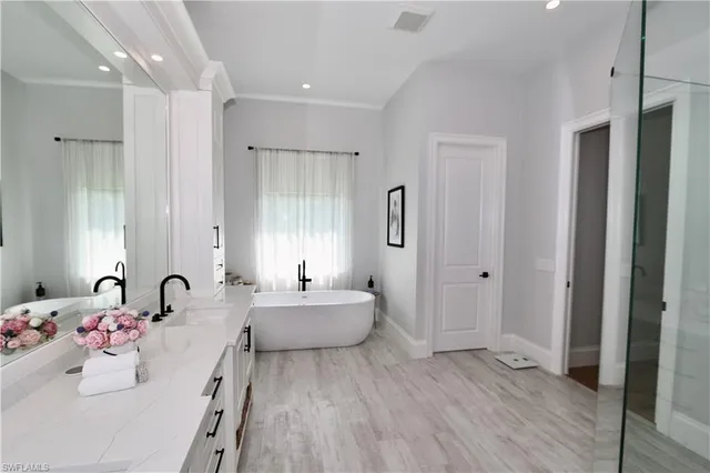 a bedroom with a bed and a flat tv screen on dresser