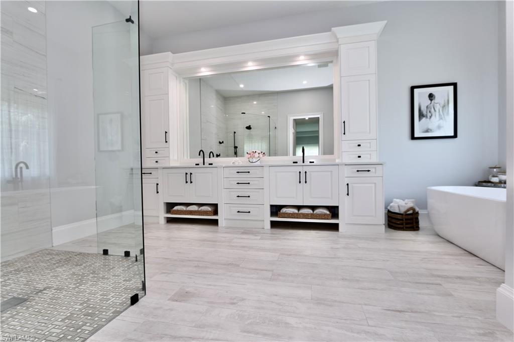 6688 Hunters Road Naples, FL 34109 - Photo 18 of 43 a spacious bathroom with double vanity and a shower