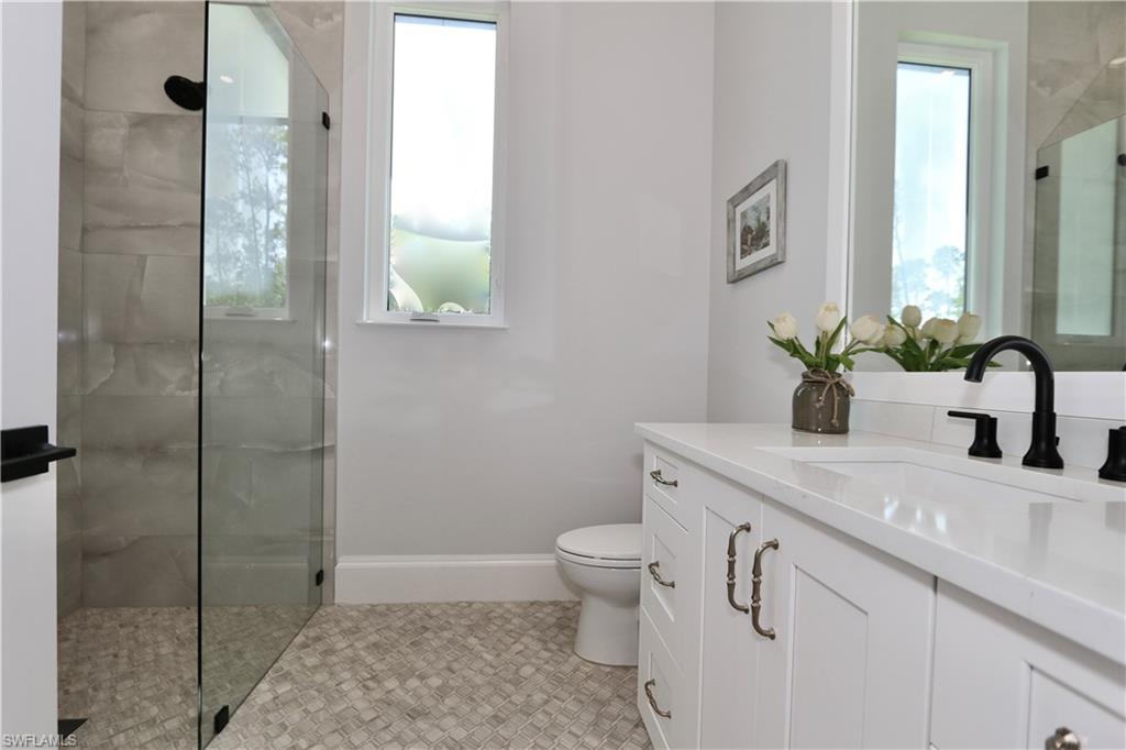 6688 Hunters Road Naples, FL 34109 - Photo 21 of 43 a bathroom with a sink a toilet and shower