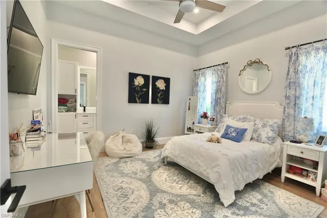 a bedroom with a bed a mirror and a window