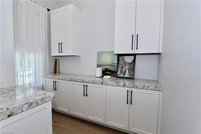 a kitchen that has a stove and a table in it