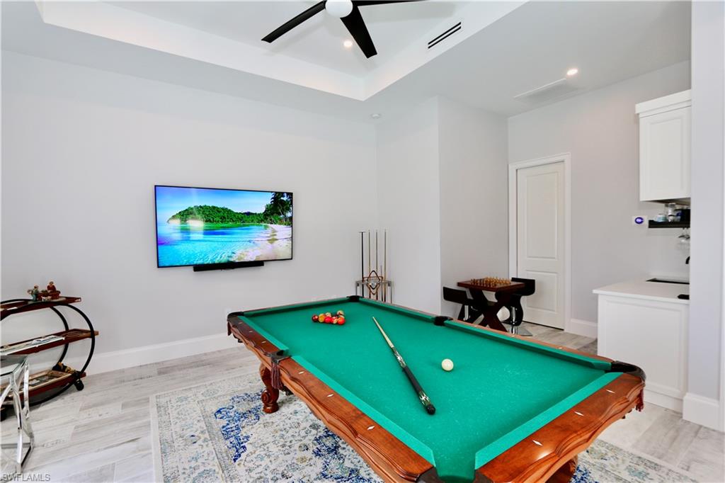 6688 Hunters Road Naples, FL 34109 - Photo 31 of 43 a room with pool table and windows