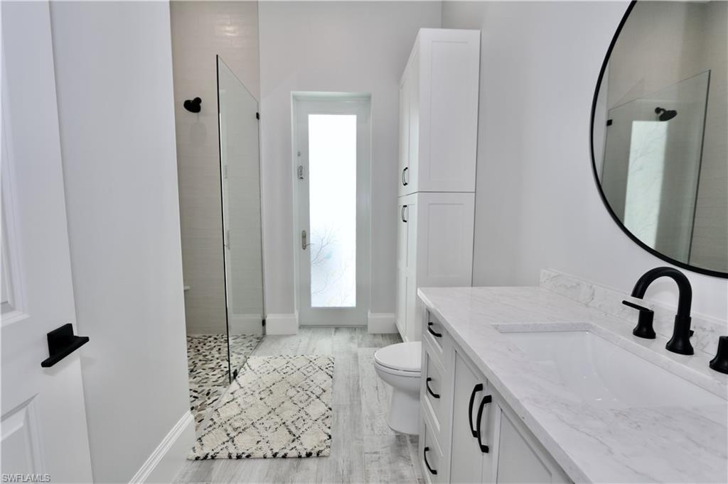 6688 Hunters Road Naples, FL 34109 - Photo 32 of 43 a bathroom with a sink and a mirror