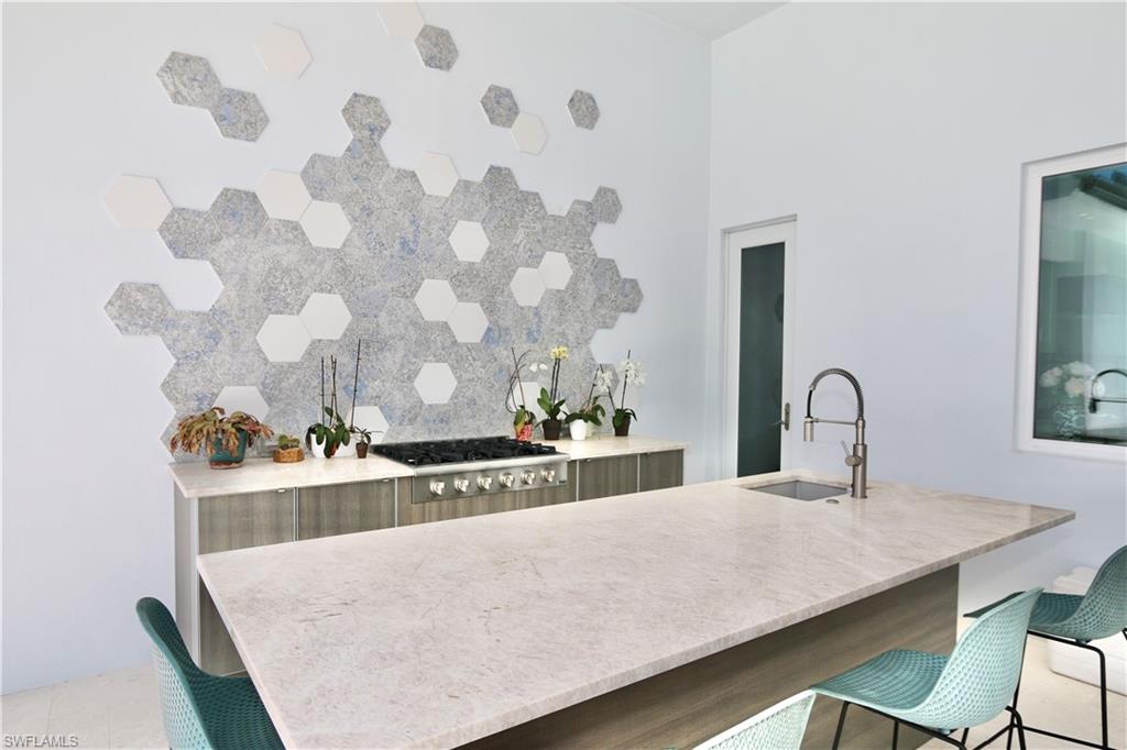 6688 Hunters Road Naples, FL 34109 - Photo 37 of 43 a kitchen with a table and chairs