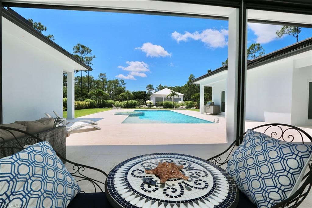 6688 Hunters Road Naples, FL 34109 - Photo 38 of 43 a view of a living room and chair