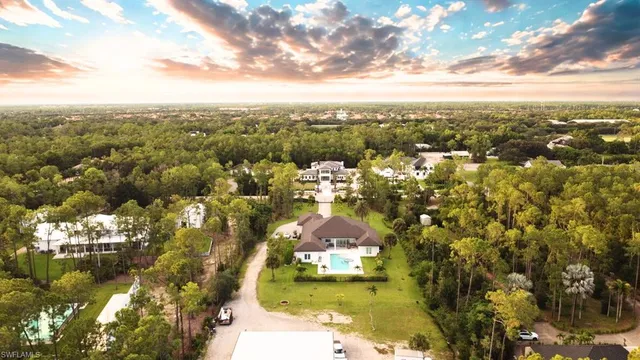 an aerial view of residential houses with yard