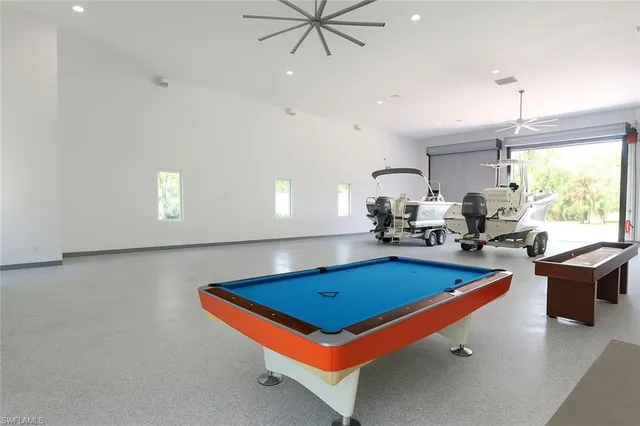 a room with furniture pool table and windows
