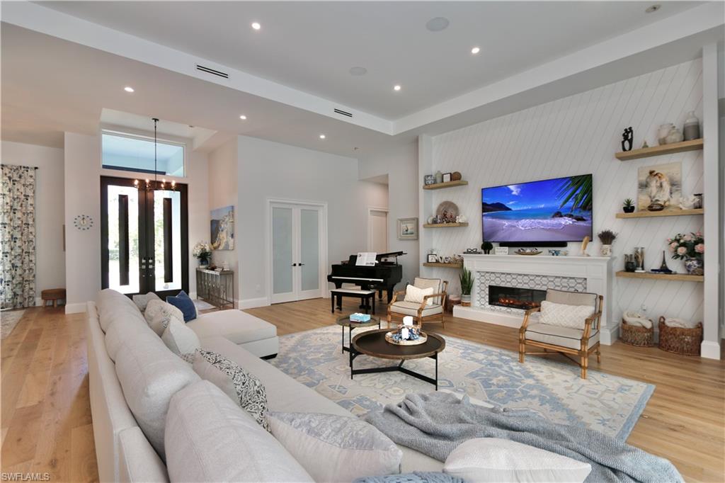 6688 Hunters Road Naples, FL 34109 - Photo 7 of 43 a living room with furniture and a flat screen tv