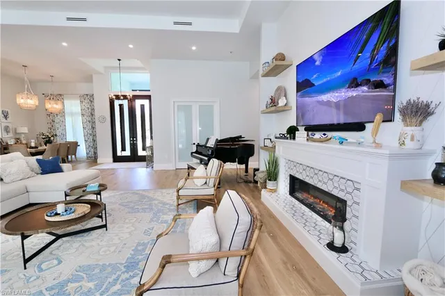 a living room with furniture a fireplace and a flat screen tv