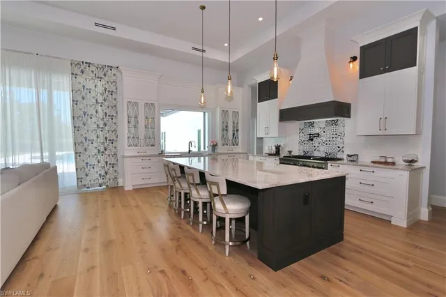 a kitchen with granite countertop a sink appliances and cabinets