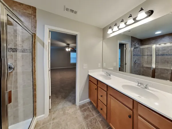 a bathroom with a double vanity sink and a mirror