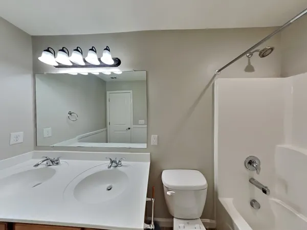 a bathroom with a sink mirror and toilet