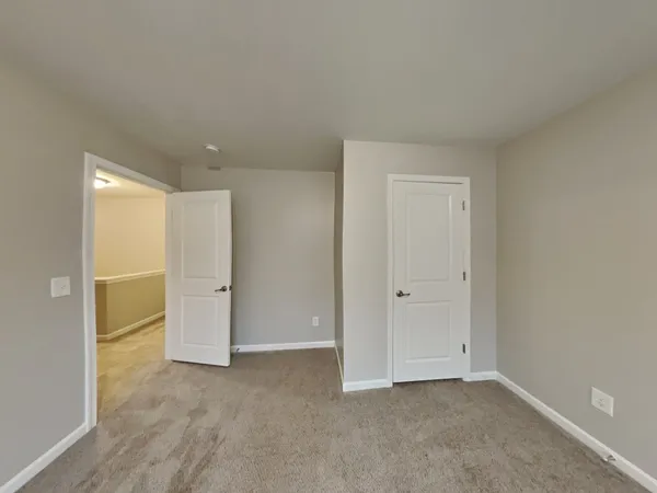 a view of an empty room and closet area