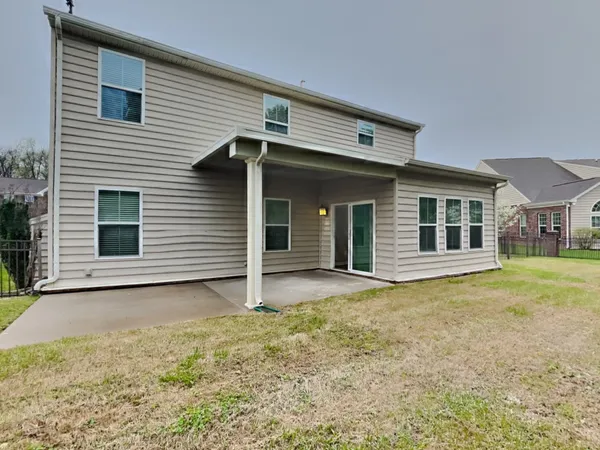 a view of a house with a backyard