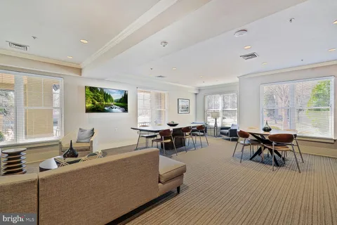 a view of a house with swimming pool and sitting area