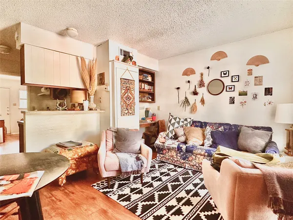 a living room with furniture and painting on the wall