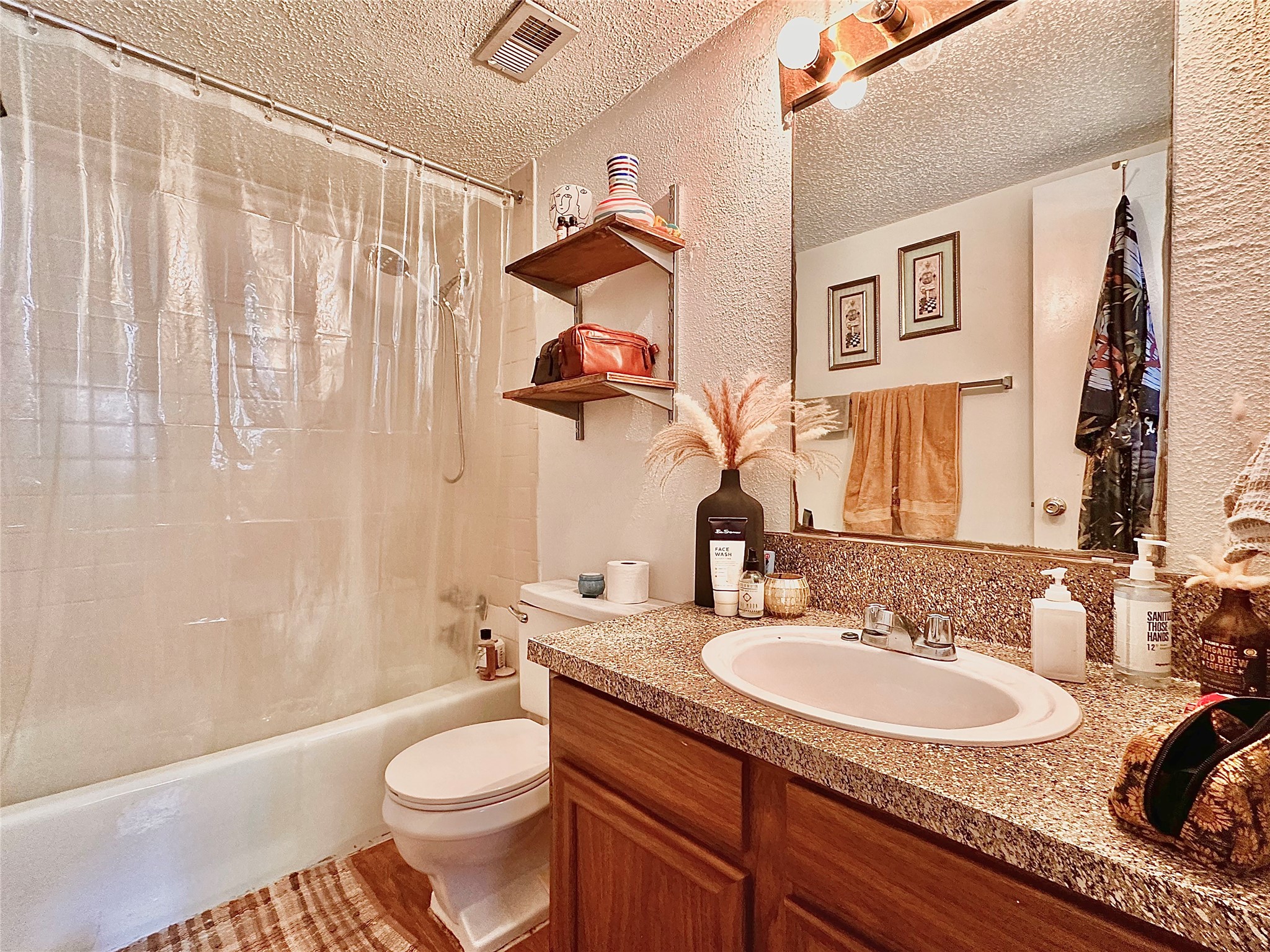 2808 Whitis Avenue, Unit C103 Austin, TX 78705 - Photo 5 of 7 a bathroom with a granite countertop sink toilet and a mirror