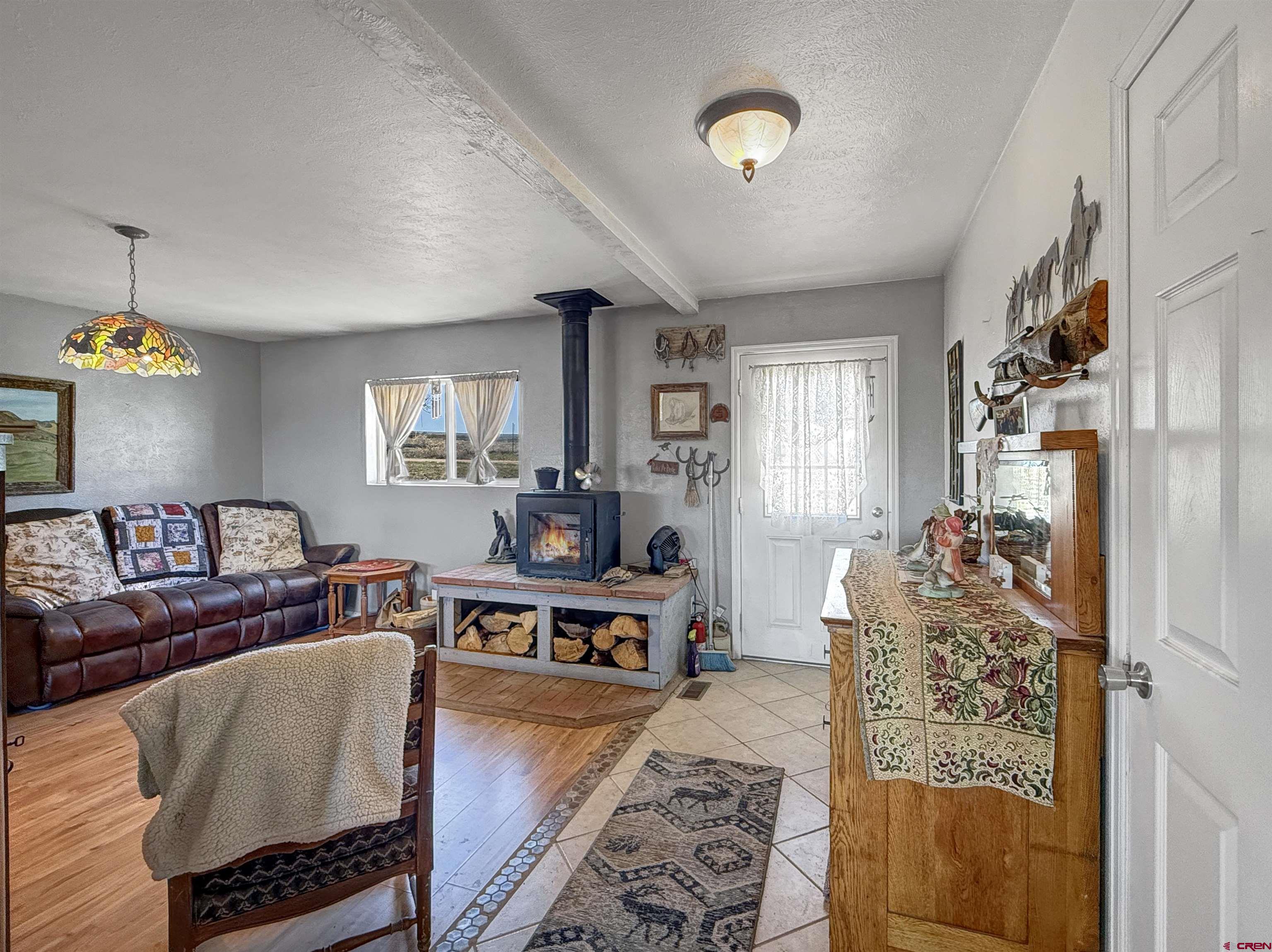 1174 3375th Road Crawford, CO 81415 - Photo 13 of 42 a living room with furniture and a chandelier