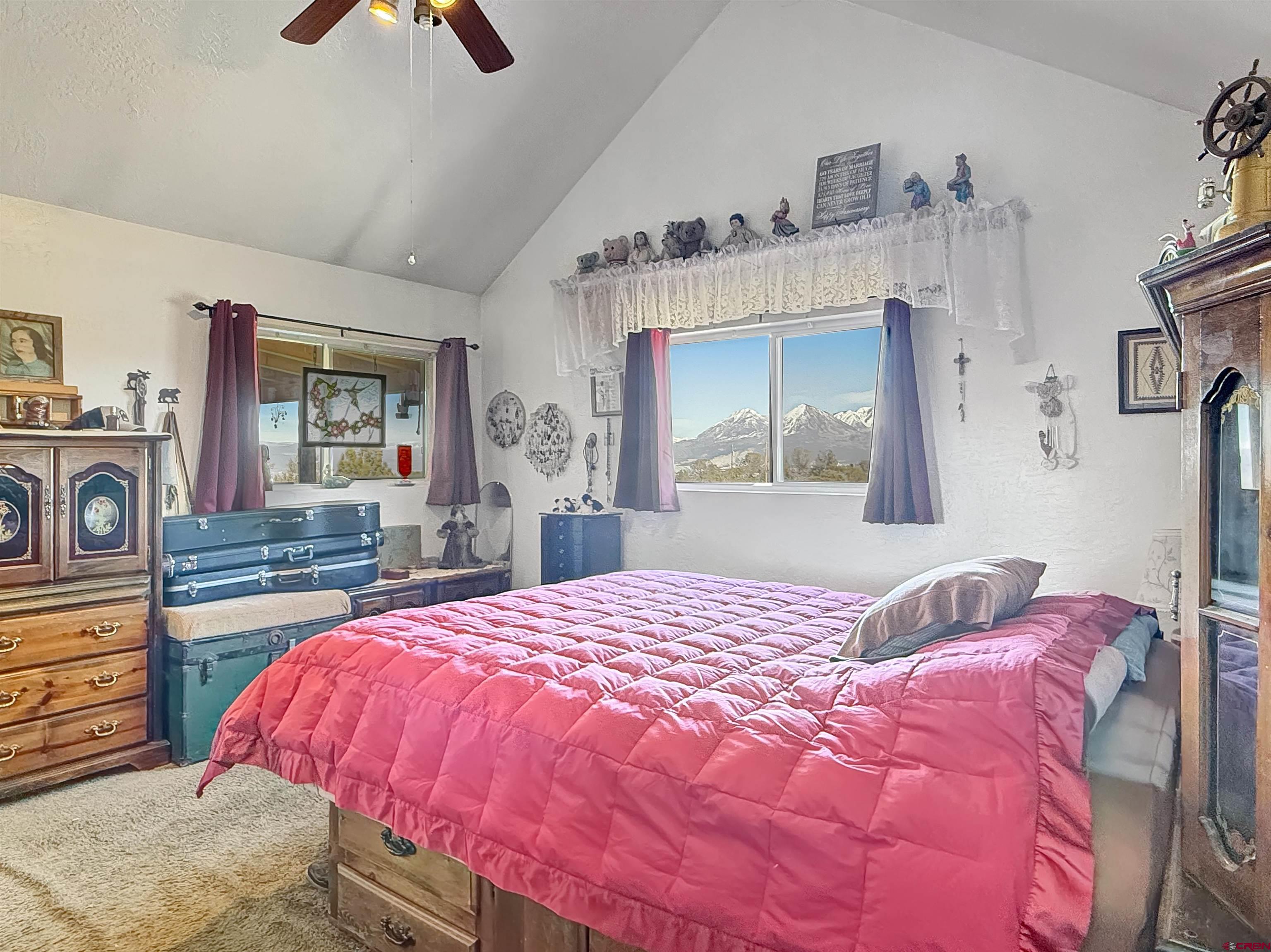 1174 3375th Road Crawford, CO 81415 - Photo 16 of 42 a bedroom with a bed and dresser with mirror