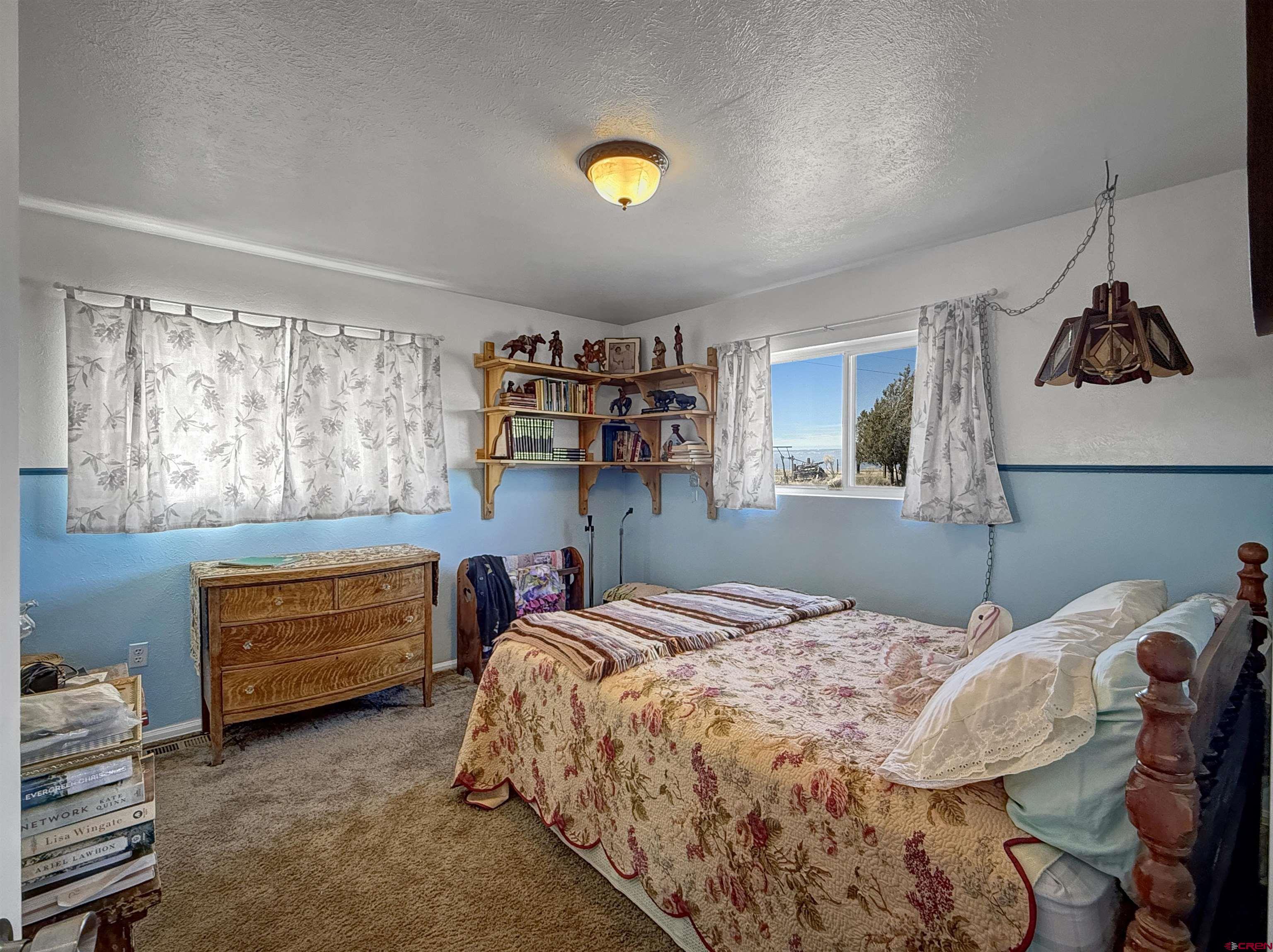 1174 3375th Road Crawford, CO 81415 - Photo 21 of 42 a bedroom with a bed and a dresser in it