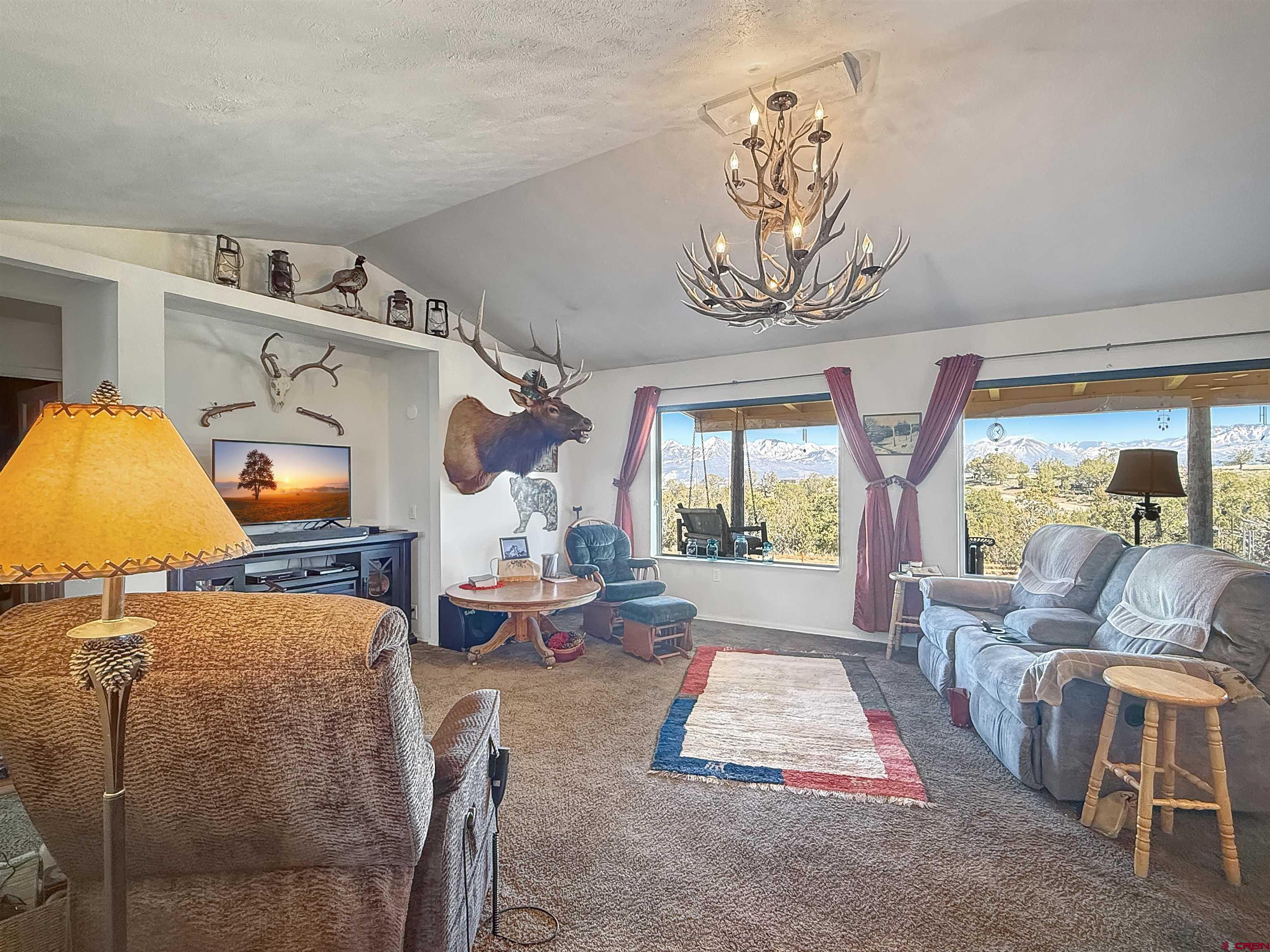 1174 3375th Road Crawford, CO 81415 - Photo 3 of 42 a living room with furniture and a flat screen tv