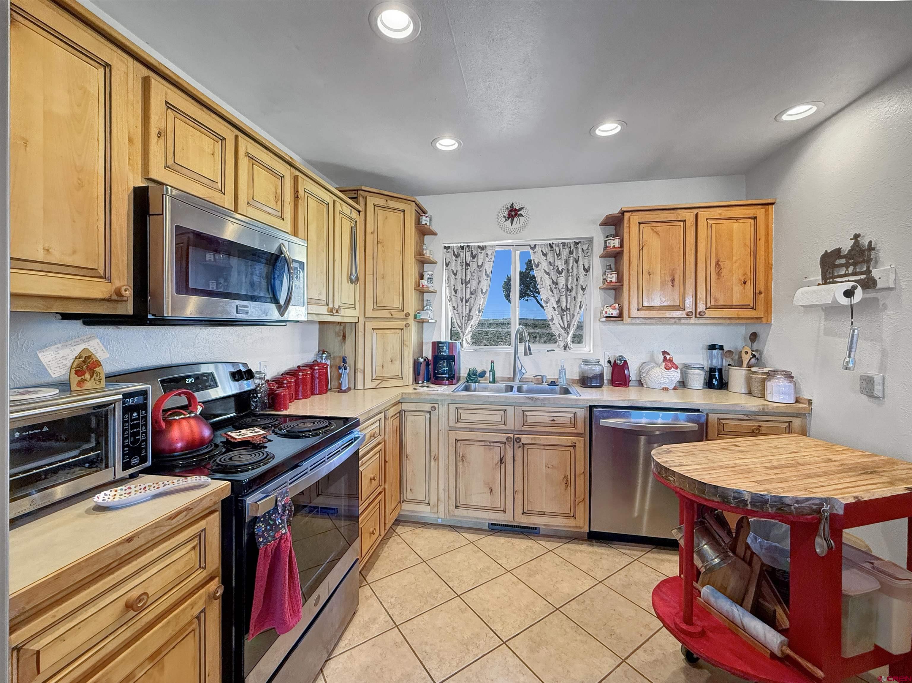 1174 3375th Road Crawford, CO 81415 - Photo 7 of 42 a kitchen with stainless steel appliances granite countertop a sink stove and cabinets